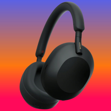 Sony WH-1000XM5 on a blue to red background