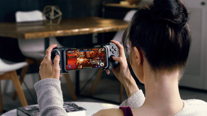 Person using Razer Kishi V2 mobile gaming controller
