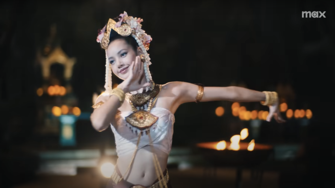 A woman poses during a dance at night.