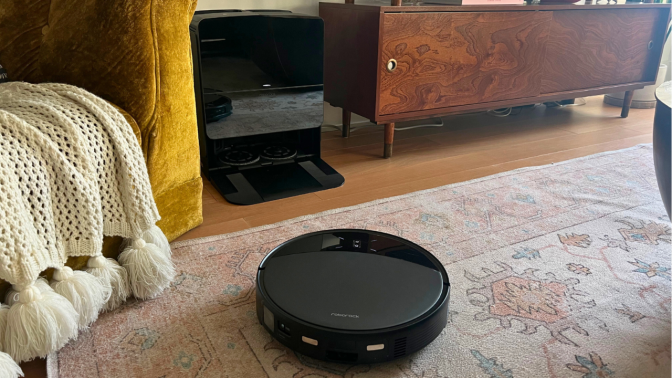 Roborock Saros 10R robot vacuum cleaning rug in living room setup